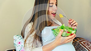 Pregnancy eating healthy salad. Happy pregnant woman eating nutrition food. People lifestyle food concept.