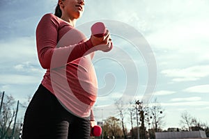 Pregnancy exercise. Pregnant woman training yoga sport exercise. Prenatal healthy fitness active fit gym outside