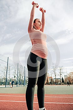 Pregnancy exercise. Pregnant woman training yoga sport exercise. Prenatal healthy fitness active fit gym outside