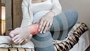 Pregnancy foot ankle pain. Pregnant woman have leg disease, ankle pain doing health massage exercise. Leg cramps during