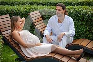 Pregnancy. Happy couple . Relax on the sun loungers