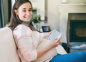 This pregnancy has been a breeze so far. Cropped portrait of an attractive young pregnant woman working from home.