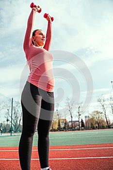 Pregnancy health. Prenatal healthy fitness active fit gym outside. Pregnant woman training yoga sport exercise