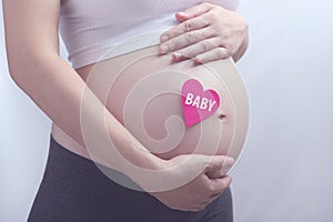 Pregnancy with with heart shaped card