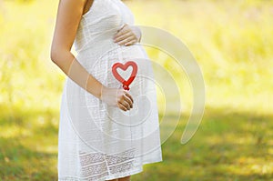 Pregnancy, maternity, family - concept, pregnant woman and heart