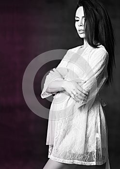 Pregnancy, maternity, preparation and expectation concept. Beautiful fashion pregnant woman holds hands on belly