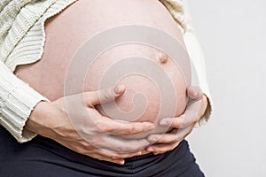 Pregnancy, motherhood, people and expectation concept - close up of happy pregnant woman with big belly