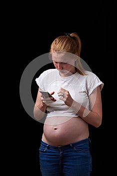 Pregnancy, motherhood, technology, people and expectation concept - sad pregnant woman calling on smartphone at home