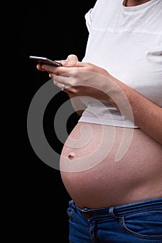pregnancy, motherhood, technology, people and expectation concept - sad pregnant woman calling on smartphone at home. upset
