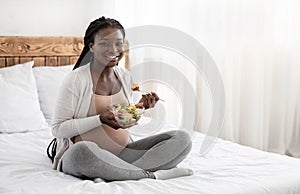 Pregnancy And Nutrition. Black Pregnant Lady Enjoying Fresh Vegetable Salad At Home
