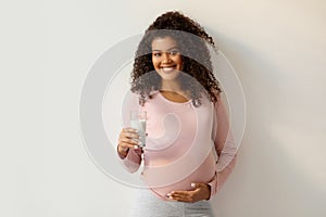 Pregnancy Nutrition. Portrait Of Black Smiling Pregnant Woman With Glass Of Milk