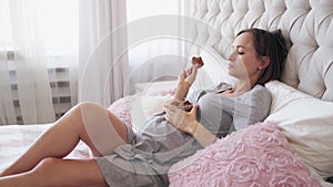 Pregnancy and nutrition. Pregnancy, unhealthy eating, food and people concept - close up of pregnant woman with cookies