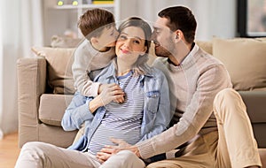 Happy family with pregnant mother at home