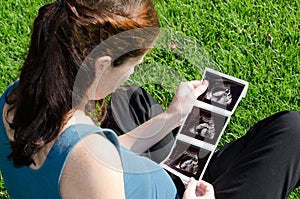 Pregnancy - Pregnant woman looking at ultrasound scan