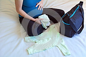 Pregnancy - pregnant woman packing a Hospital Bag