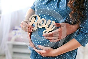 Pregnancy. It& x27;s a boy. Future parents hug and wait for the baby