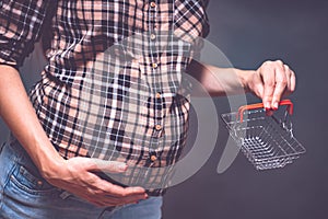 pregnancy shopping, motherhood, people and expectation concept - pregnant woman with shopping bag touching her big belly