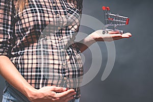 pregnancy shopping, motherhood, people and expectation concept - pregnant woman with shopping bag touching her big belly