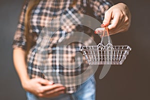 pregnancy shopping, motherhood, people and expectation concept - pregnant woman with shopping bag touching her big belly