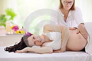 Pregnancy spa. Massage for pregnant woman