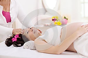 Pregnancy spa. Massage for pregnant woman