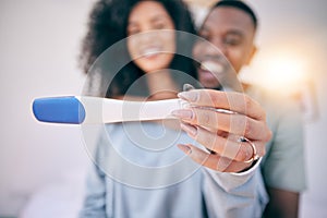 Pregnancy test, happiness and black couple in a home with a smile from baby news. Support, care and blurred background