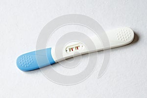 Pregnancy test positive result on clinic table