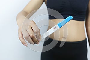 Pregnancy test tool in woman`s hand