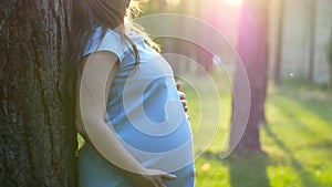Pregnant 9 month woman dreaming near tree