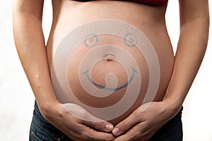 Pregnant abdomen with smile