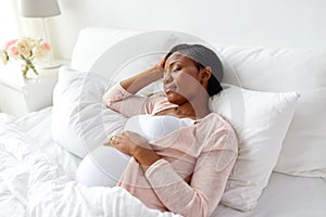 Pregnant african american woman sleeping at home