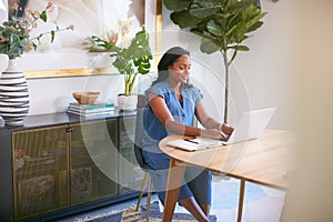 Pregnant African American Woman Using Laptop At Table Working From Home