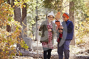 Pregnant Asian mother and family hiking in forest, close up