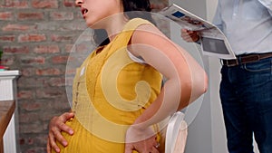 Pregnant Asian woman having back pain