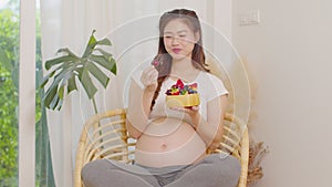 Pregnant asian woman holding fresh berry fruit Blueberries strawberries and eating for high vitamin C.Pregnancy Berry Fruits with