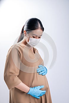 Pregnant asian woman in medical mask for protect coronavirus covid-19