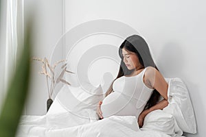 Pregnant asian woman suffering from back pain