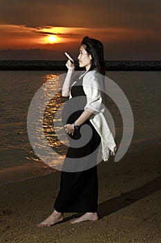 Pregnant Asian Woman and Sunset