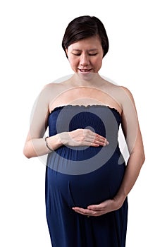 Pregnant asian woman supporting her belly with hands.