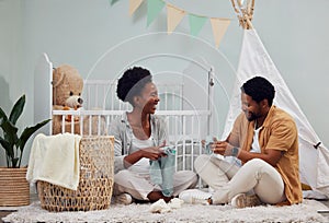 Pregnant and baby room and black couple happy to prepare for a family home and folding clothes. Man and woman together