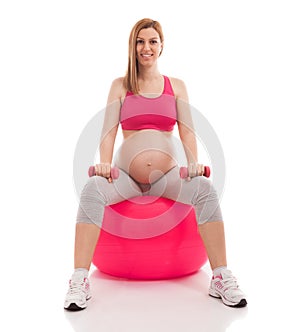Pregnant beautiful woman exercise with ball and dumbbells