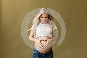 Pregnant beautiful Young happy Woman touching her belly