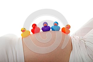 Pregnant belly with colorful rubber ducks