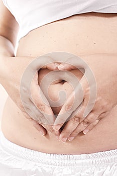 Pregnant Belly with fingers Heart symbol