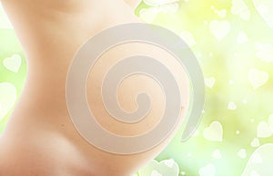 Pregnant belly on a green abstract background