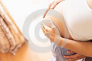 Pregnant belly hands. Happy pregnancy woman and husband hugging pregnant belly. Concept maternity, pregnancy, childbirth