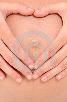 Pregnant Belly with Heart Shape Hands