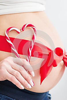 Pregnant belly with red heart