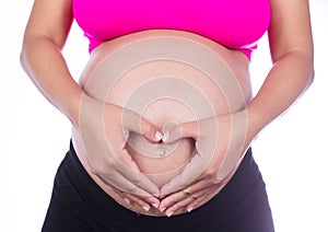 Pregnant Belly of woman with fingers Heart shape on white background