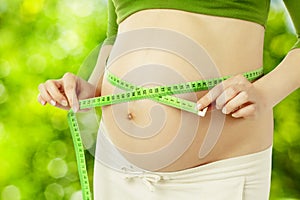Pregnant belly, woman measure stomach. Prenatal health care photo